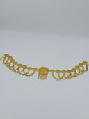 Full flat lay view of the gold-tone filigree coin disc waist belt showing the full length, repeating disc links, swag charm drops, and central medallion with chain tassel