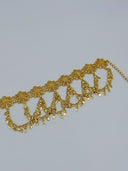 Three-quarter view of the waist belt showing the extension chain closure end, repeating filigree rosette medallions, and diamond charm drops along the swag chains