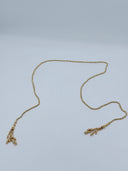 Full flat lay view of the gold-tone faceted bead lariat waist chain showing the full length and both tassel drop ends