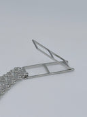 Close-up of the geometric open-frame bar clasp closure and the end of the clover-link mesh chain body