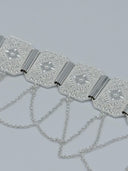 Close-up of three octagonal panels showing the dense faceted diamond-cut texture, raised eight-pointed star motifs, polished bar hinges, and swag cable chain drops
