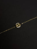 Gold necklace with a pendant on a black background