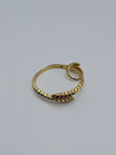 Close-up of gold-tone Serpenti-inspired pavé hinged bangle showing alternating high-polish and crystal scale segments with double-coil serpent terminal