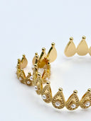 Flat lay of the Couronne Pearl Set showing the open-cuff bangle, stud earrings, and crown ring arranged together on a white surface