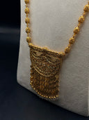 Close-up of the Sultana fan pendant showing layered arabesque scrollwork, open arch cutouts, and cascading filigree clover drops with pearl-tone bead tips on a filigree bead chain