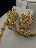 Detail view of the Sultana fan earrings showing the arabesque scrollwork face with clear stone centres and pearl-tone tassel drops, alongside the filigree sphere bead chain