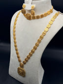 Full view of a 4-piece gold-tone jewelry set on a bust display, showing a long square-link necklace with rectangular pendant, matching choker, and drop earrings