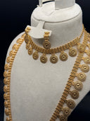 Full view of a 3-piece gold-tone medallion coin jewelry set displayed on a bust — choker necklace, opera-length necklace, and drop earrings with circular sunburst pendants