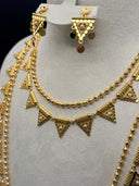 Back view of the gold-tone necklace showing the rolo-link chain extender and lobster clasp closure