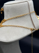 Full set view of the gold-tone triangle pendant jewelry set on a bust — choker, opera necklace, and drop earrings displayed together against a dark background
