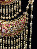 Gold-tone bracelet and floral cocktail ring displayed together on a dark surface, both featuring open filigree detailing and a central pink stone flower cluster