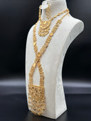 Full view of a geometric mosaic jewelry set on a white bust, showing a long plaque-link necklace with a large half-moon pendant and charm fringe, paired with matching drop earrings, against a dark background