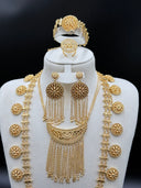 Front view of the full bridal set on a white bust showing the double crescent pendant, coin chain side strands, chandelier earrings, wide cuff bracelet, and large round cocktail ring displayed at the top