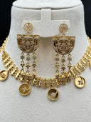 Front-facing close-up of the matching chandelier earrings showing the round disc stud tops, half-moon open filigree bodies with pave stone detailing, and multi-strand chain tassel drops with star and arrow-shaped charm finishes