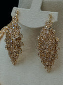 Detail of the pair of long leaf cluster chandelier earrings showing layered marquise-cut stones in a cascading leaf motif