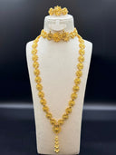 Full 4-piece filigree flower jewelry set on a white velvet bust — opera-length necklace with ball tassel drop, choker, drop earrings, and bangle bracelet