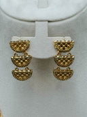 Shoulder drape chain and drop earrings on a white velvet bust showing dual strands of half-moon links with daisy spacers and decorative clasp bar