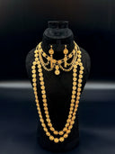 Full 3-piece jewelry set on a black velvet bust — 3-strand filigree daisy link opera necklace, shorter coin drop collar necklace with coiled bar drops, and matching drop earrings