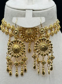 Detail of the gold-tone choker with central floral medallion and matching chandelier drop earrings