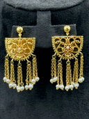 Detail of the matching half-moon filigree drop earrings with chain tassel fringe and white bead tips