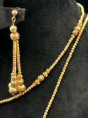 Close-up of one drop earring and the necklace chain showing the rope-cut spiral texture on each ball bead